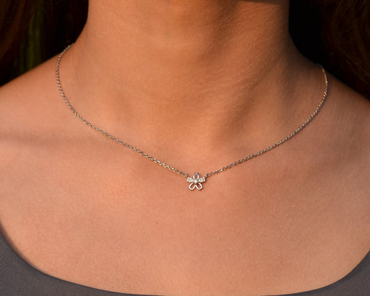 Necklace with a clover pendant worn by a person